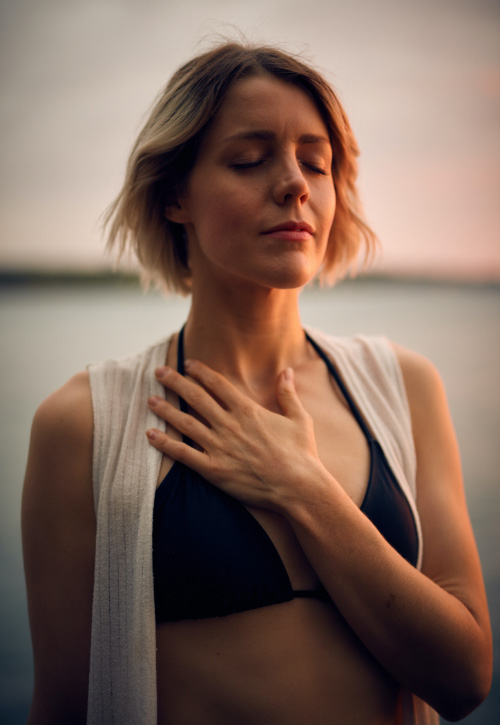 woman holding her hand over her heart